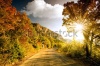 stock-photo-mountain-road-at-sunset-115353469