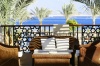 stock-photo-villa-terrace-with-wicker-furniture-and-sea-view-83065528