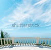 stock-photo-balcony-over-sea-and-cloudy-sky-165204215