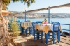 stock-photo-empty-greek-cafe-terrace-in-heraklion-crete-overlooking-the-sea-with-typical-wooden-chairs-232087465