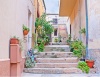 stock-photo-la-maddalena-italy-september-the-tiny-courtyard-and-the-staircase-decorated-with-2137585