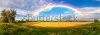 stock-photo-panorama-of-a-big-summer-field-shined-with-the-sun-with-clouds-and-rainbow-in-the-sky-on-backgr