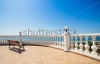 stock-photo-summer-view-with-classic-white-balustrade-bench-and-empty-terrace-overlooking-the-sea-206801095