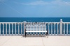 stock-photo-summer-view-with-classic-white-balustrade-bench-and-empty-terrace-overlooking-the-sea-italy-111380012