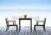 stock-photo-terrace-sea-view-with-outdoor-wood-chairs-and-table-168323384