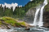 waterfalls_stock-photo-alpine-waterfall-in-mountain-forest-under-blue-sky-74748757